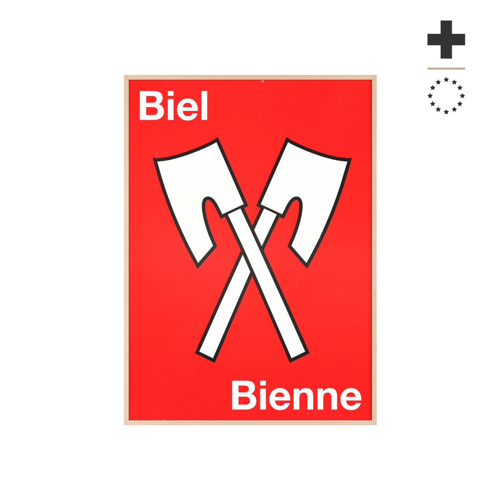 Minimalist framed wall poster of the Biel Bienne coat of arms featuring crossed white axes on a red background, displayed in a natural pinewood frame.