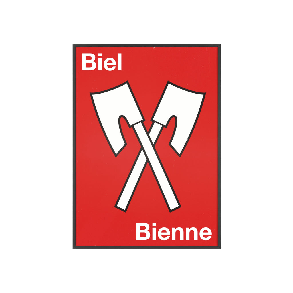 Minimalist framed wall poster of the Biel Bienne coat of arms featuring crossed white axes on a red background, displayed in a natural pinewood frame.