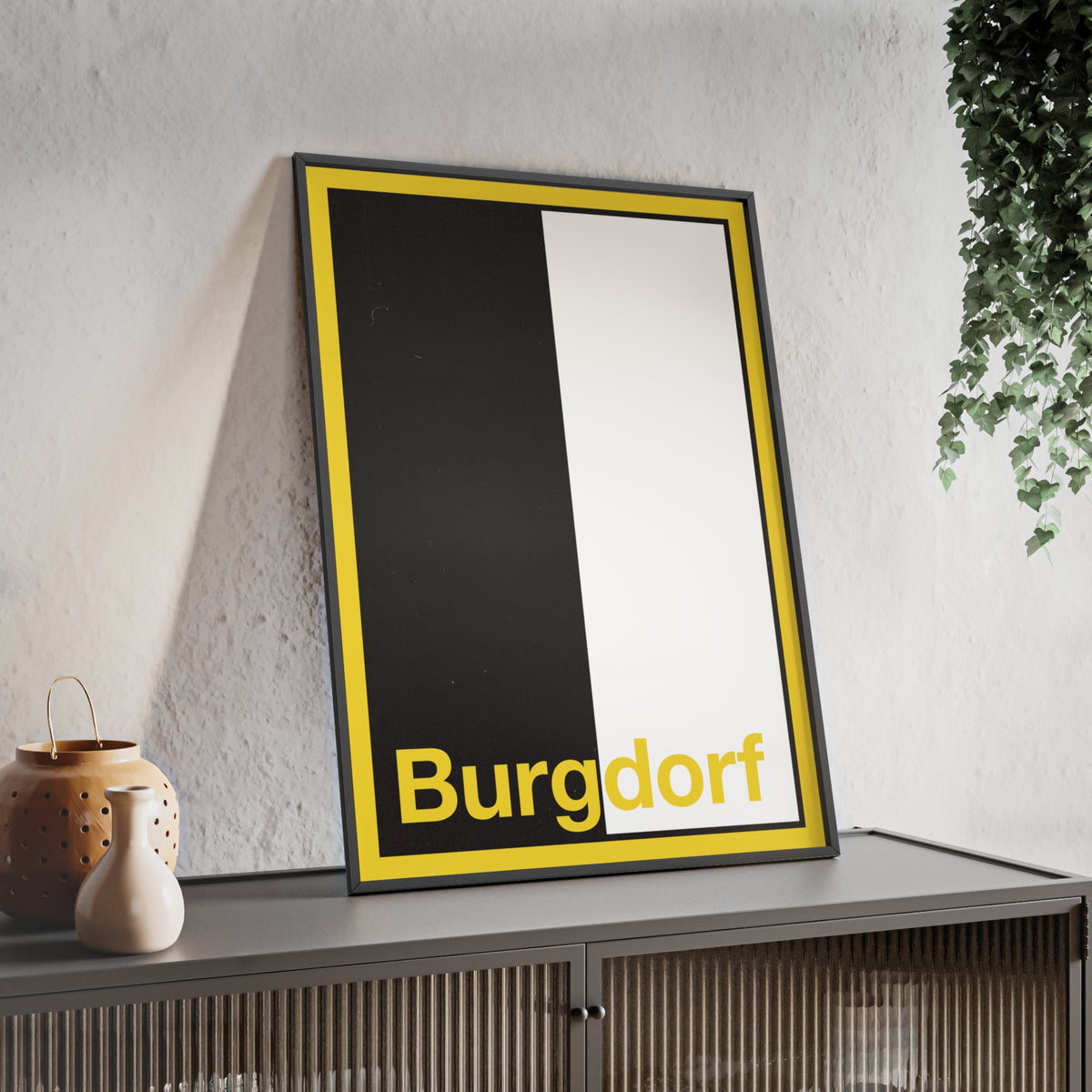 Minimalist framed wall poster of the Burgdorf coat of arms featuring vertical black and white panels with a yellow border, displayed in a natural pinewood frame.