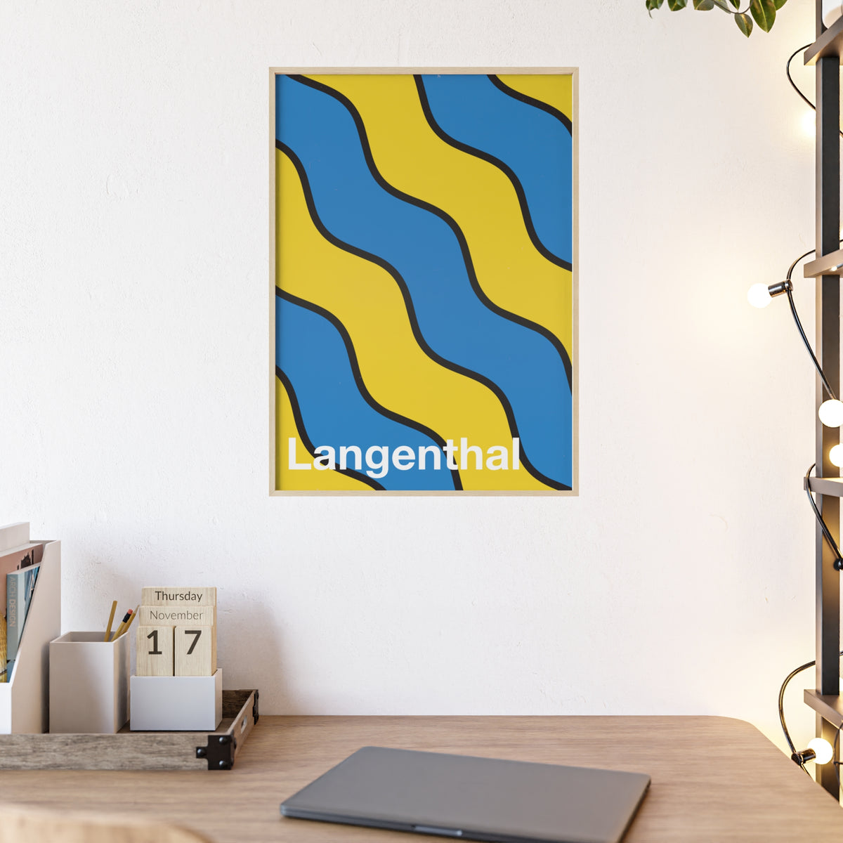 Minimalist framed poster of the Langenthal coat of arms featuring blue and yellow wavy stripes, set in a natural wood frame on an interior console table.