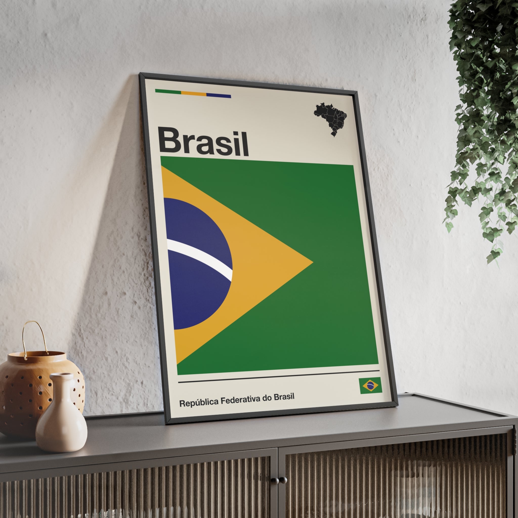 Minimalist framed Brazil flag poster in modernist style, featuring a green and yellow geometric design on an off-white background with 'Brasil' and 'República Federativa do Brasil' typography. Large 50x70 cm vertical format in a natural pinewood frame.