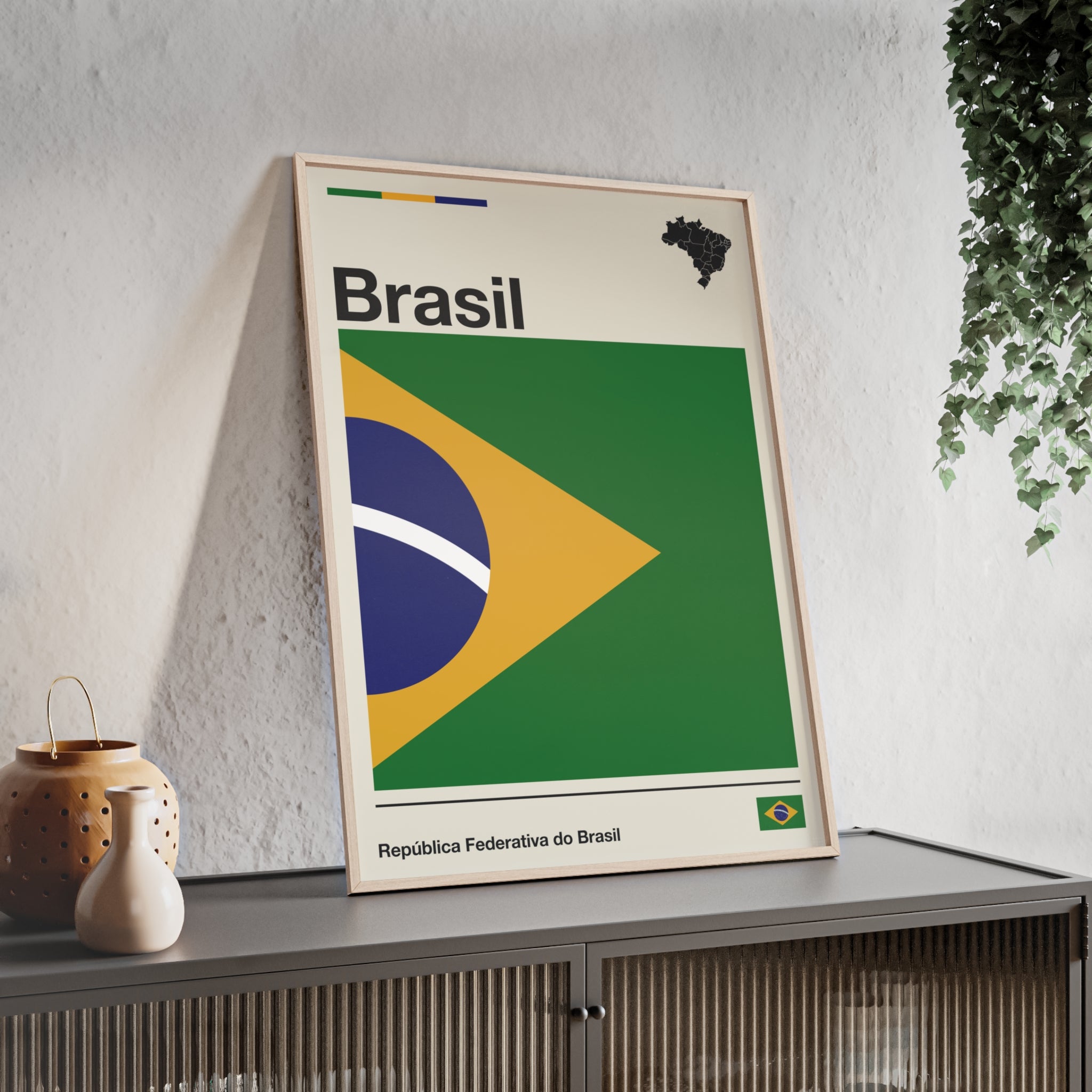 Minimalist framed Brazil flag poster in modernist style, featuring a green and yellow geometric design on an off-white background with 'Brasil' and 'República Federativa do Brasil' typography. Large 50x70 cm vertical format in a natural pinewood frame.