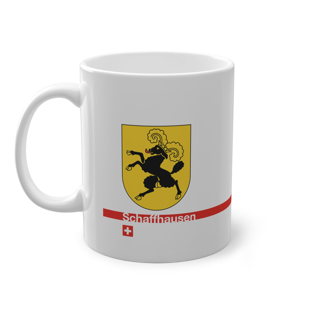 White ceramic mug featuring the golden Canton of Schaffhausen coat of arms with a black ram, a modern red horizontal line with 'Schaffhausen' text, and a small Swiss cross below.