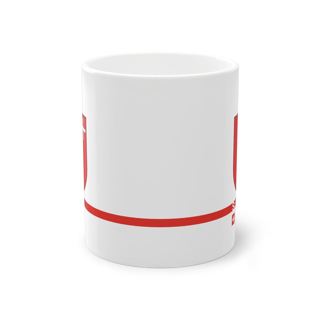 White ceramic mug featuring the red Canton of Schwyz coat of arms with a small white cross, a modern red horizontal line with 'Schwyz' text, and a small Swiss cross below.