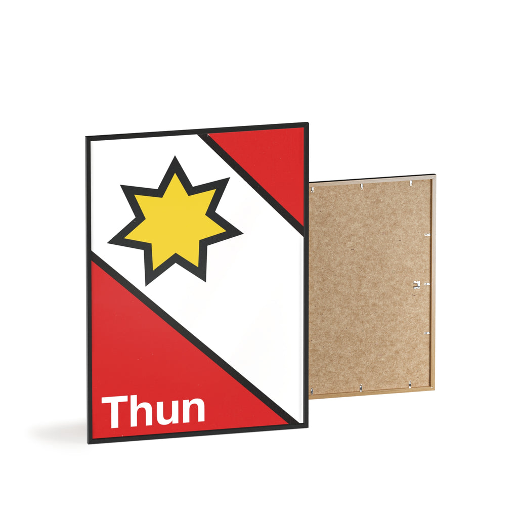 Minimalist framed poster of the Thun coat of arms featuring a yellow star on red and white diagonal fields, displayed in a natural wood frame on a console table.