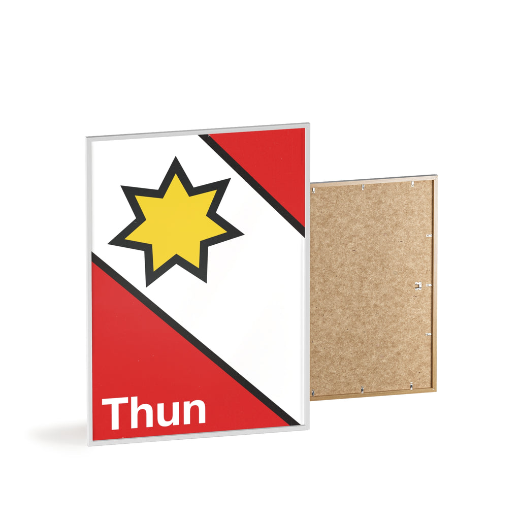 Minimalist framed poster of the Thun coat of arms featuring a yellow star on red and white diagonal fields, displayed in a natural wood frame on a console table.