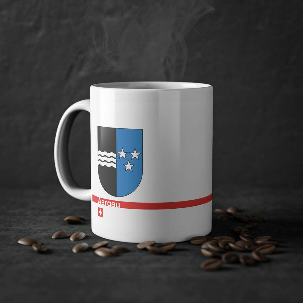 White ceramic mug with the vertically divided coat of arms of the Canton of Aargau (black with silver waves and blue with stars), featuring a modern red line and a small Swiss cross.