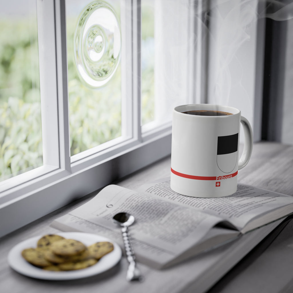 White ceramic mug with the black and white horizontally divided coat of arms of the Canton of Fribourg, Switzerland, featuring a modern red line and a small Swiss cross.