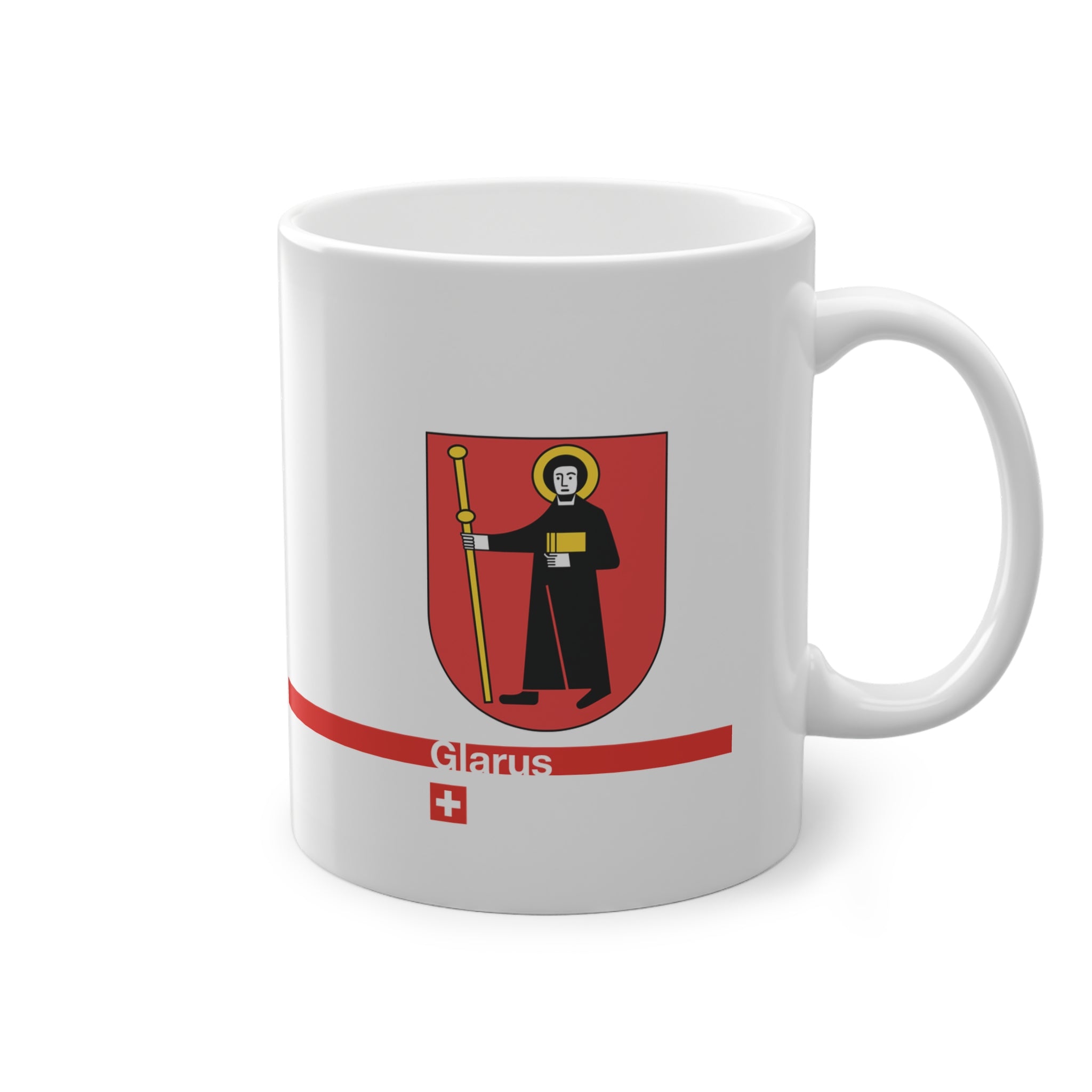 White ceramic mug with the red Canton of Glarus coat of arms featuring Saint Fridolin, a modern red line with 'Glarus' text and a small Swiss cross.