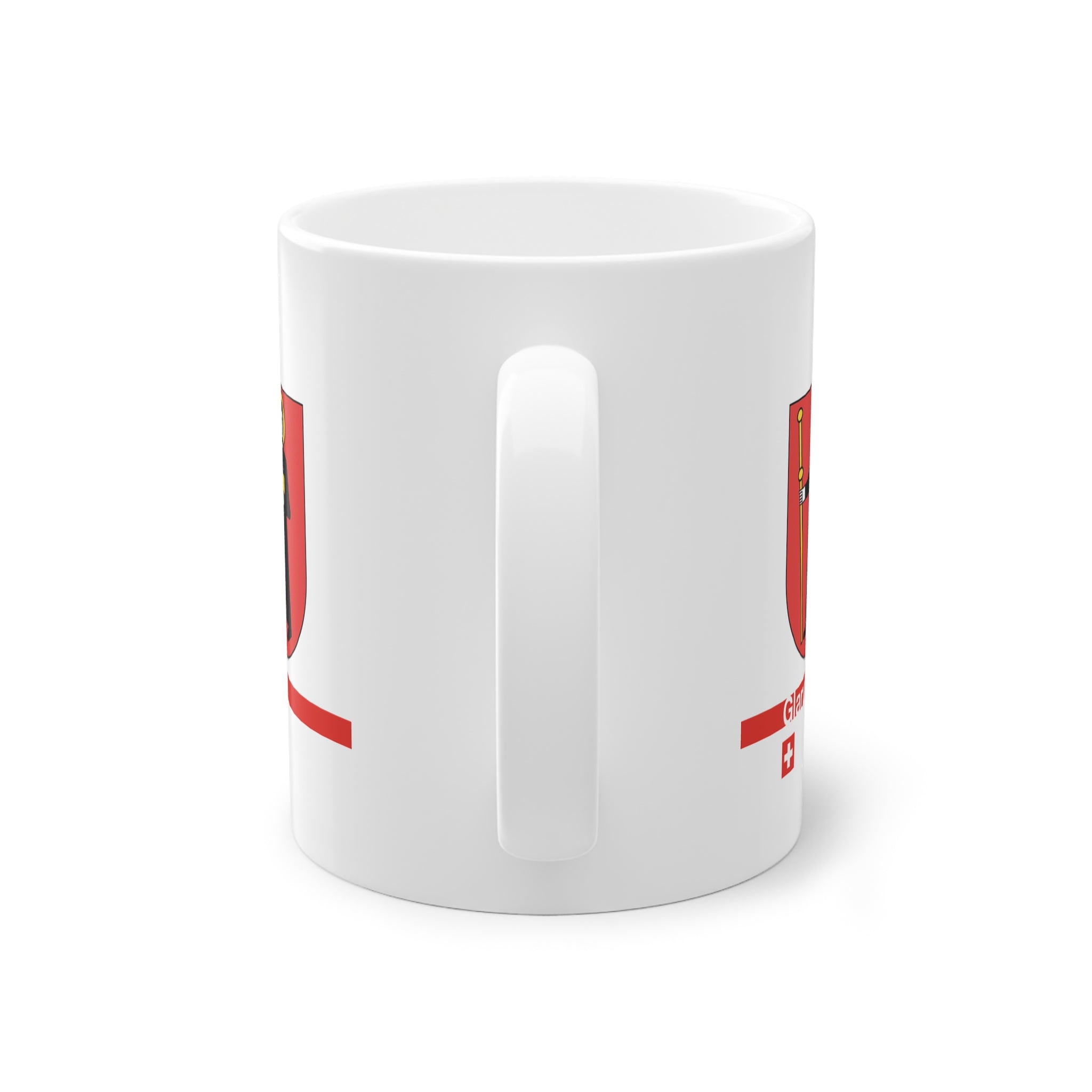 White ceramic mug with the red Canton of Glarus coat of arms featuring Saint Fridolin, a modern red line with 'Glarus' text and a small Swiss cross.