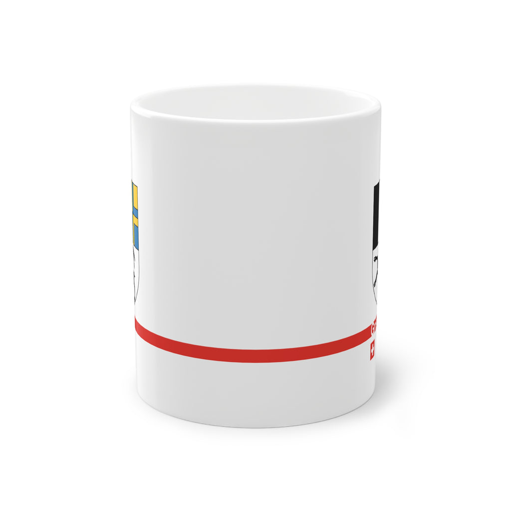White ceramic mug with the Canton of Grisons (Graubünden) coat of arms featuring the black ibex, blue and yellow fields, a modern red line with 'Grisons' text, and a small Swiss cross.