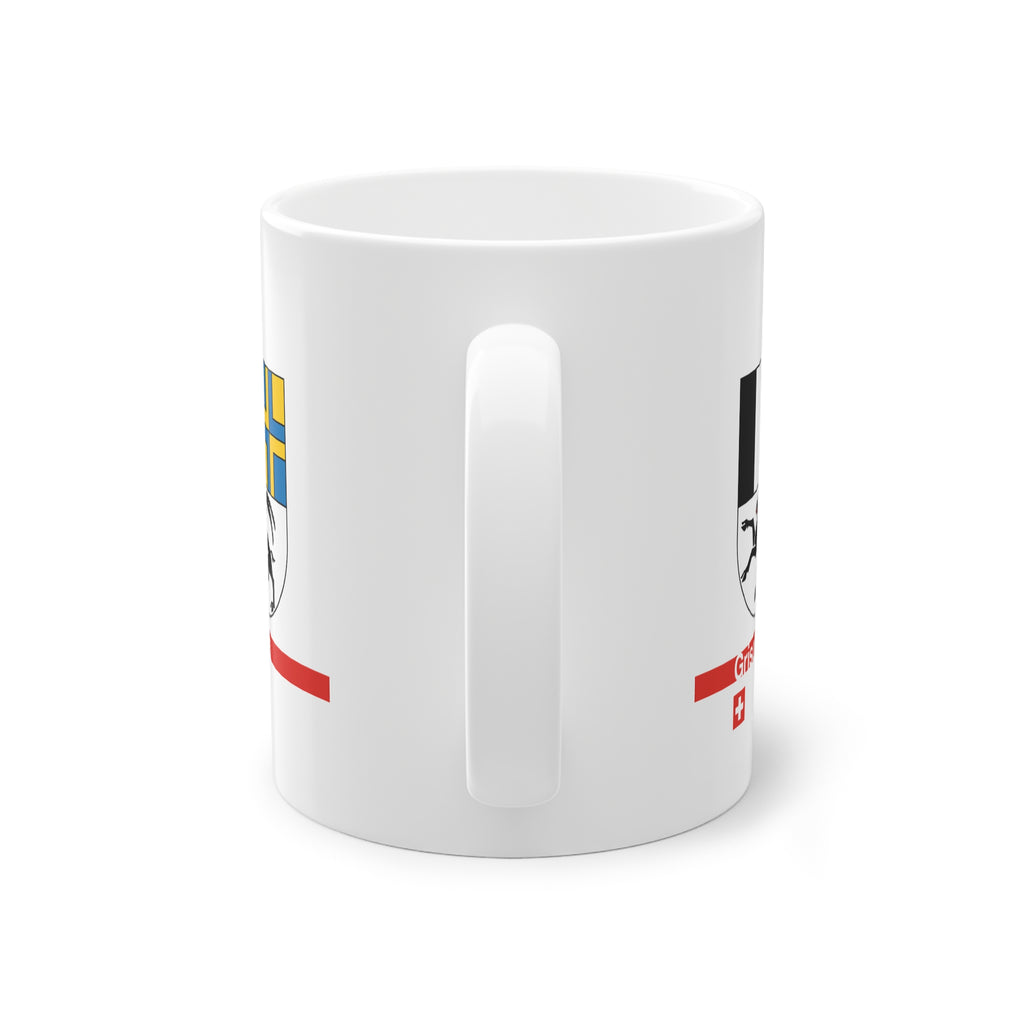White ceramic mug with the Canton of Grisons (Graubünden) coat of arms featuring the black ibex, blue and yellow fields, a modern red line with 'Grisons' text, and a small Swiss cross.