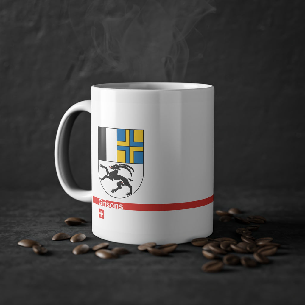White ceramic mug with the Canton of Grisons (Graubünden) coat of arms featuring the black ibex, blue and yellow fields, a modern red line with 'Grisons' text, and a small Swiss cross.