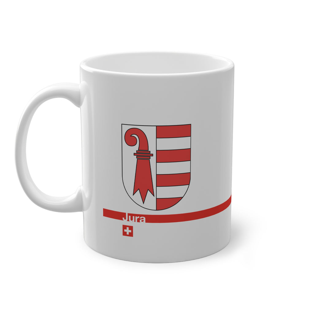 White ceramic mug featuring the red and white Canton of Jura coat of arms (bishop's crosier and seven stripes), a modern red horizontal line with 'Jura' text, and a small Swiss cross below.