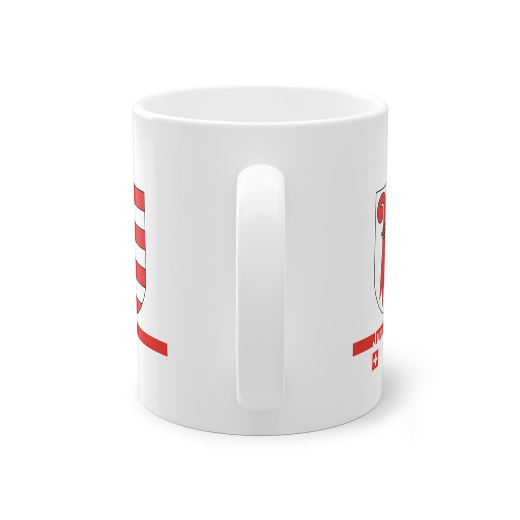 White ceramic mug featuring the red and white Canton of Jura coat of arms (bishop's crosier and seven stripes), a modern red horizontal line with 'Jura' text, and a small Swiss cross below.