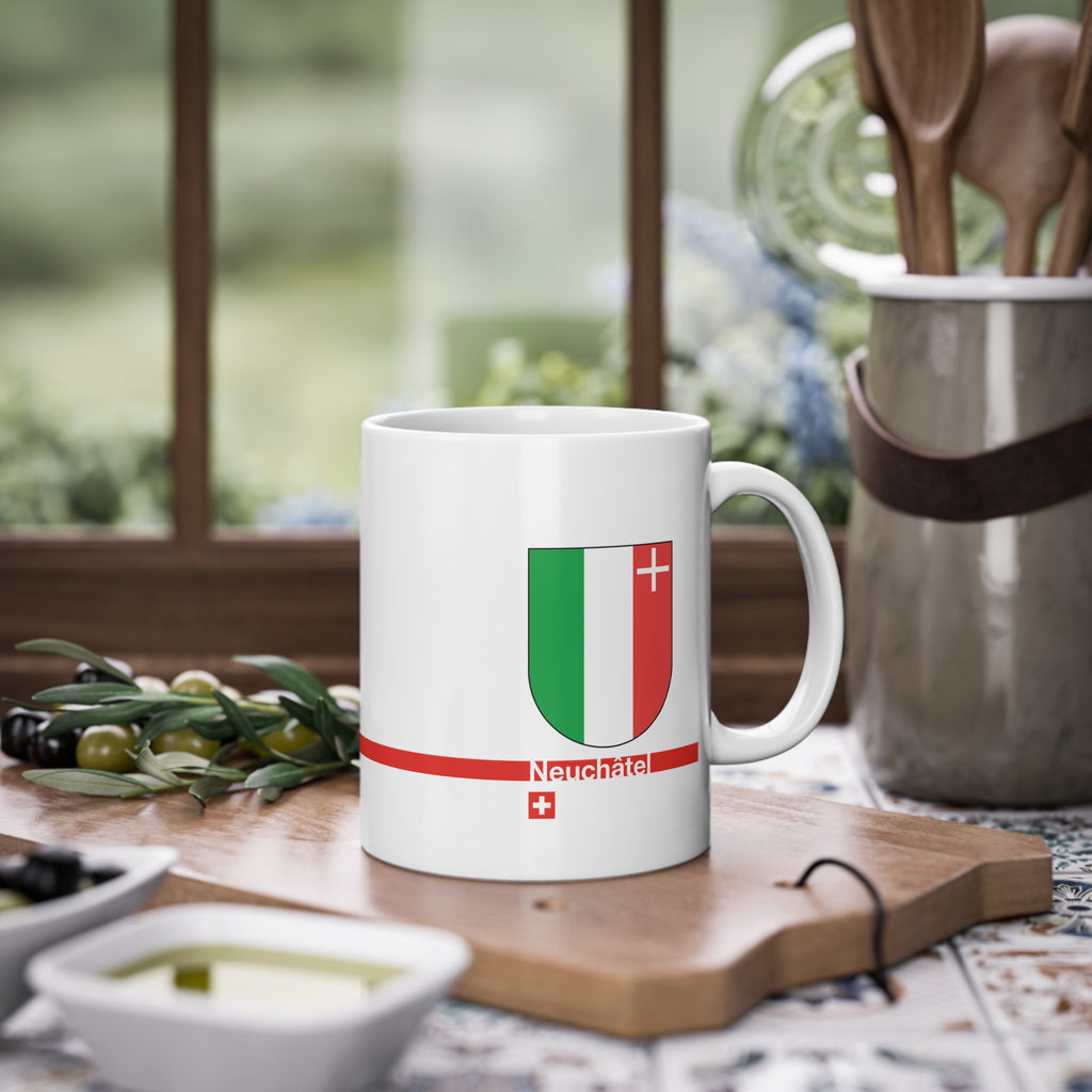 White ceramic mug featuring the green, white, and red vertical coat of arms of the Canton of Neuchâtel, a modern red horizontal line with 'Neuchâtel' text, and a small Swiss cross below.