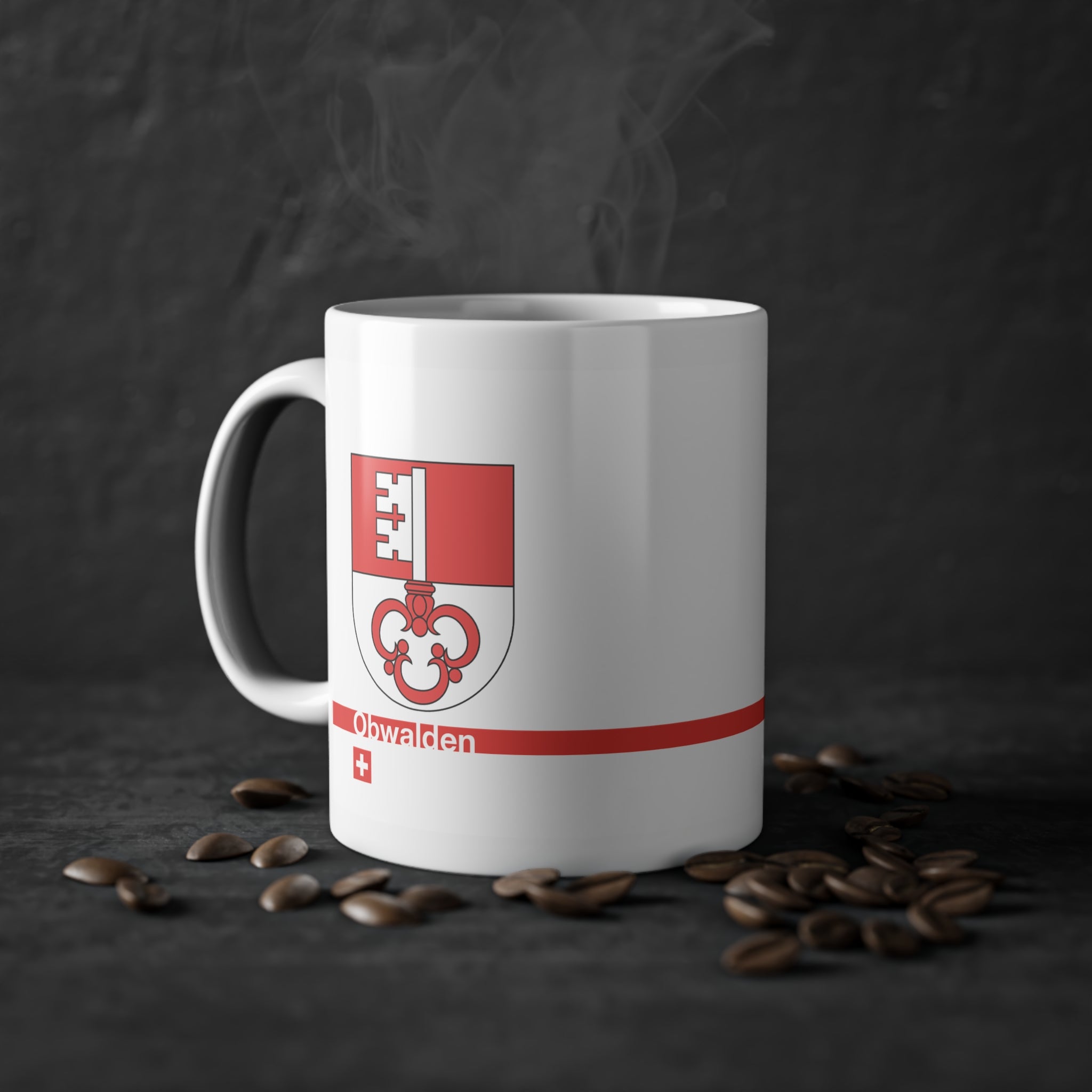 White ceramic mug featuring the red and white split Canton of Obwalden coat of arms (single white key), a modern red horizontal line with 'Obwalden' text, and a small Swiss cross below.