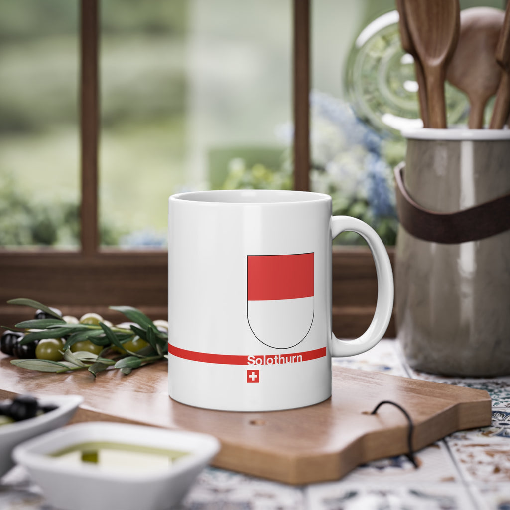 White ceramic mug featuring the red and white horizontal coat of arms of the Canton of Solothurn, a modern red horizontal line with 'Solothurn' text, and a small Swiss cross below.