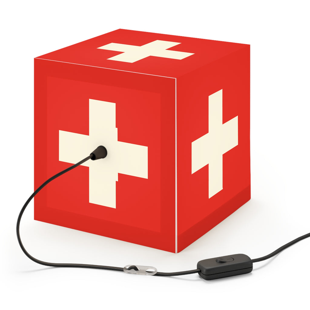 Minimalist cube-shaped lamp featuring the red and white Swiss cross flag design. Available in regular 30 cm and small 20 cm sizes, shown as a geometric lighting fixture with a matte finish, perfect for modern home decor and Swiss National Day 1st of August celebrations.