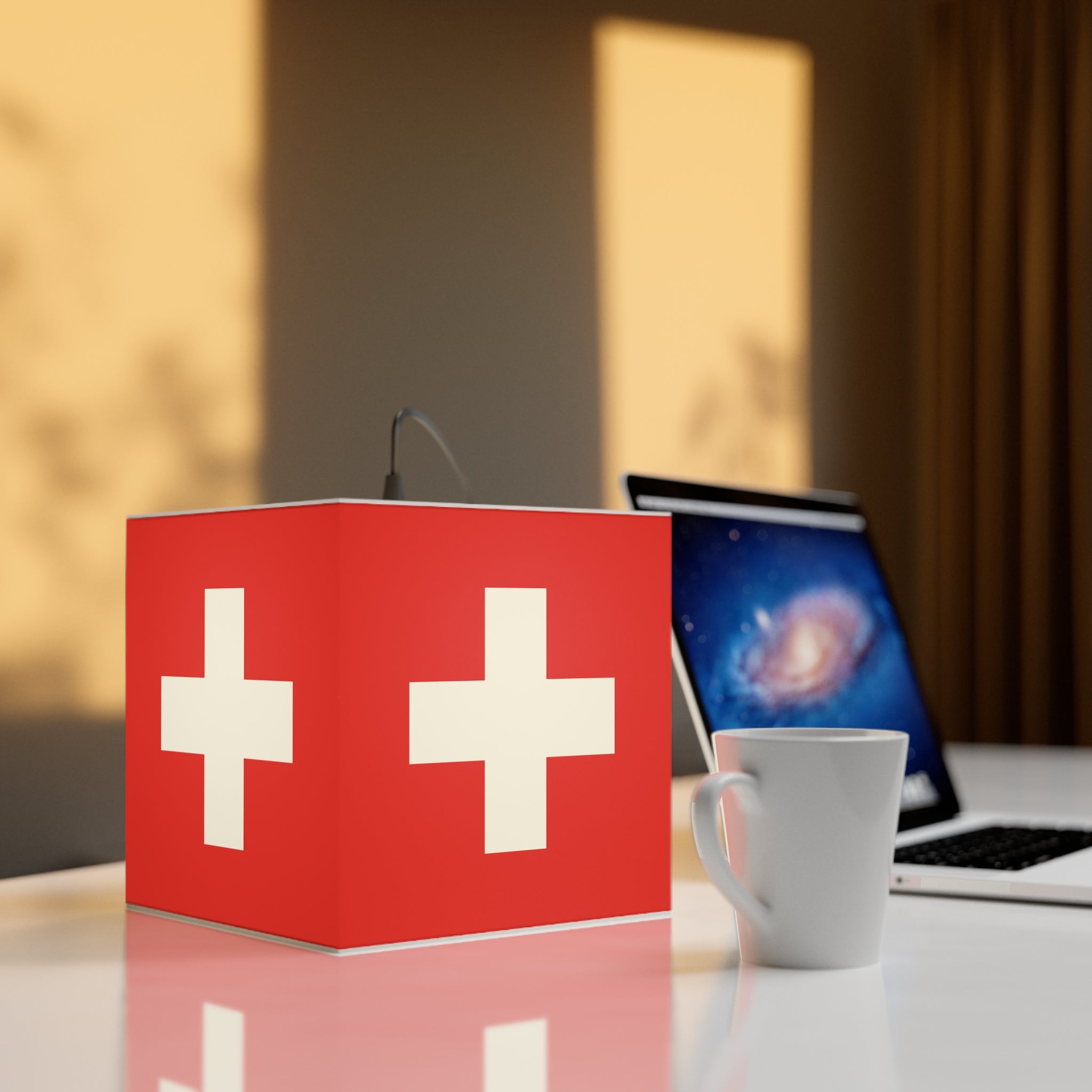 Minimalist cube-shaped lamp featuring the red and white Swiss cross flag design. Available in regular 30 cm and small 20 cm sizes, shown as a geometric lighting fixture with a matte finish, perfect for modern home decor and Swiss National Day 1st of August celebrations.