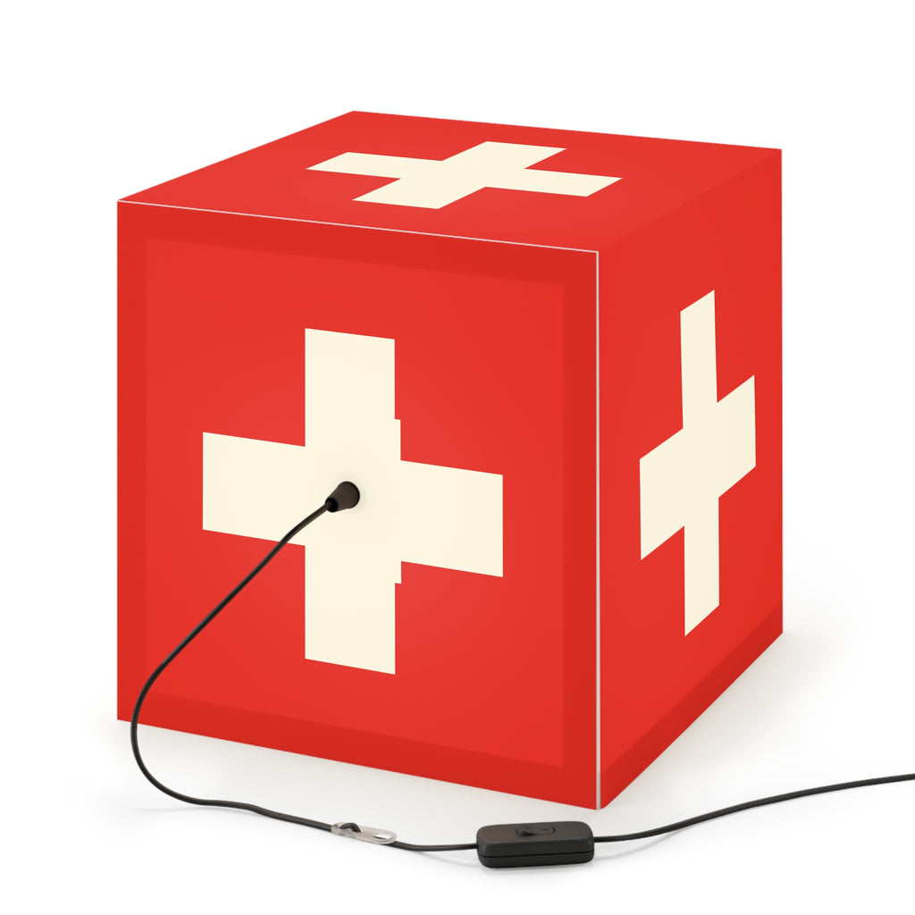 Minimalist cube-shaped lamp featuring the red and white Swiss cross flag design. Available in regular 30 cm and small 20 cm sizes, shown as a geometric lighting fixture with a matte finish, perfect for modern home decor and Swiss National Day 1st of August celebrations.