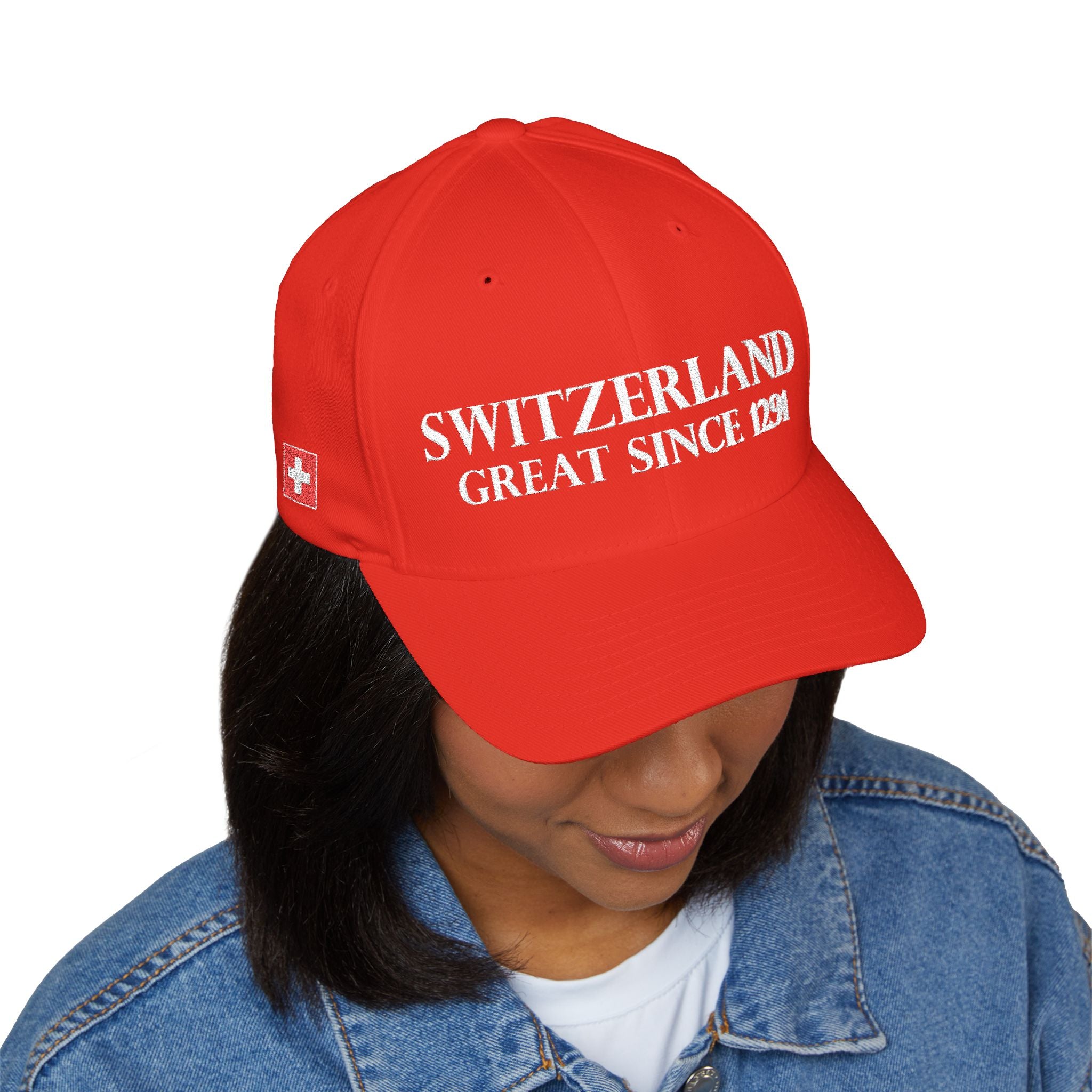 Product multi-angle mockup views of a premium red structured Swiss baseball cap. Front features white 'SWITZERLAND GREAT SINCE 1291' embroidery. Right side displays the Swiss cross flag, left side features country names in German, French, Italian, and Romansh, and the closed back shows a circular CH logo.