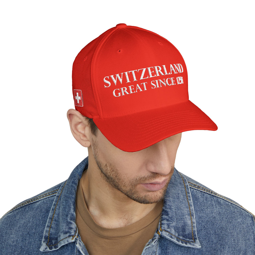 Product multi-angle mockup views of a premium red structured Swiss baseball cap. Front features white 'SWITZERLAND GREAT SINCE 1291' embroidery. Right side displays the Swiss cross flag, left side features country names in German, French, Italian, and Romansh, and the closed back shows a circular CH logo.