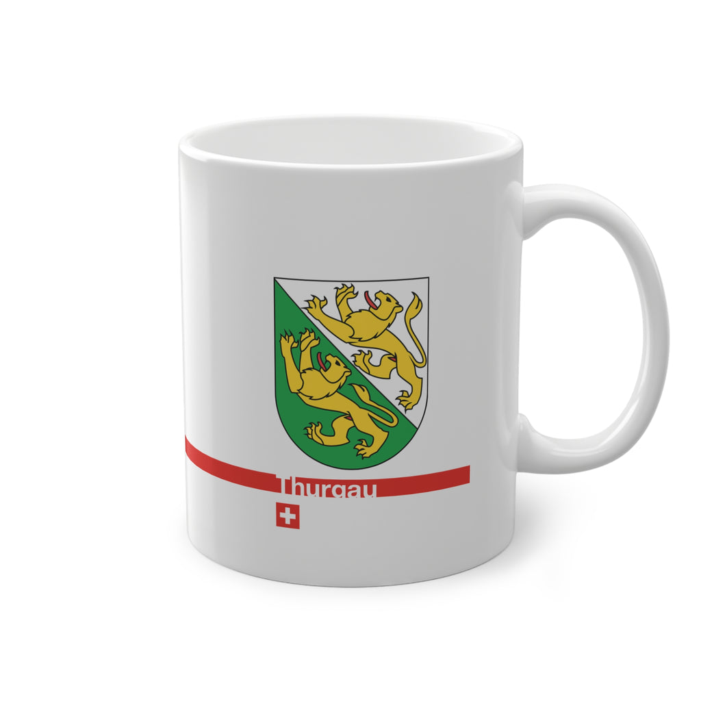White ceramic mug featuring the green and white Canton of Thurgau coat of arms with two golden lions, a modern red horizontal line with 'Thurgau' text, and a small Swiss cross below.
