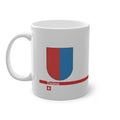 White ceramic mug with the red and blue vertically divided coat of arms of the Canton of Ticino, Switzerland, featuring a modern red line and a small Swiss cross.