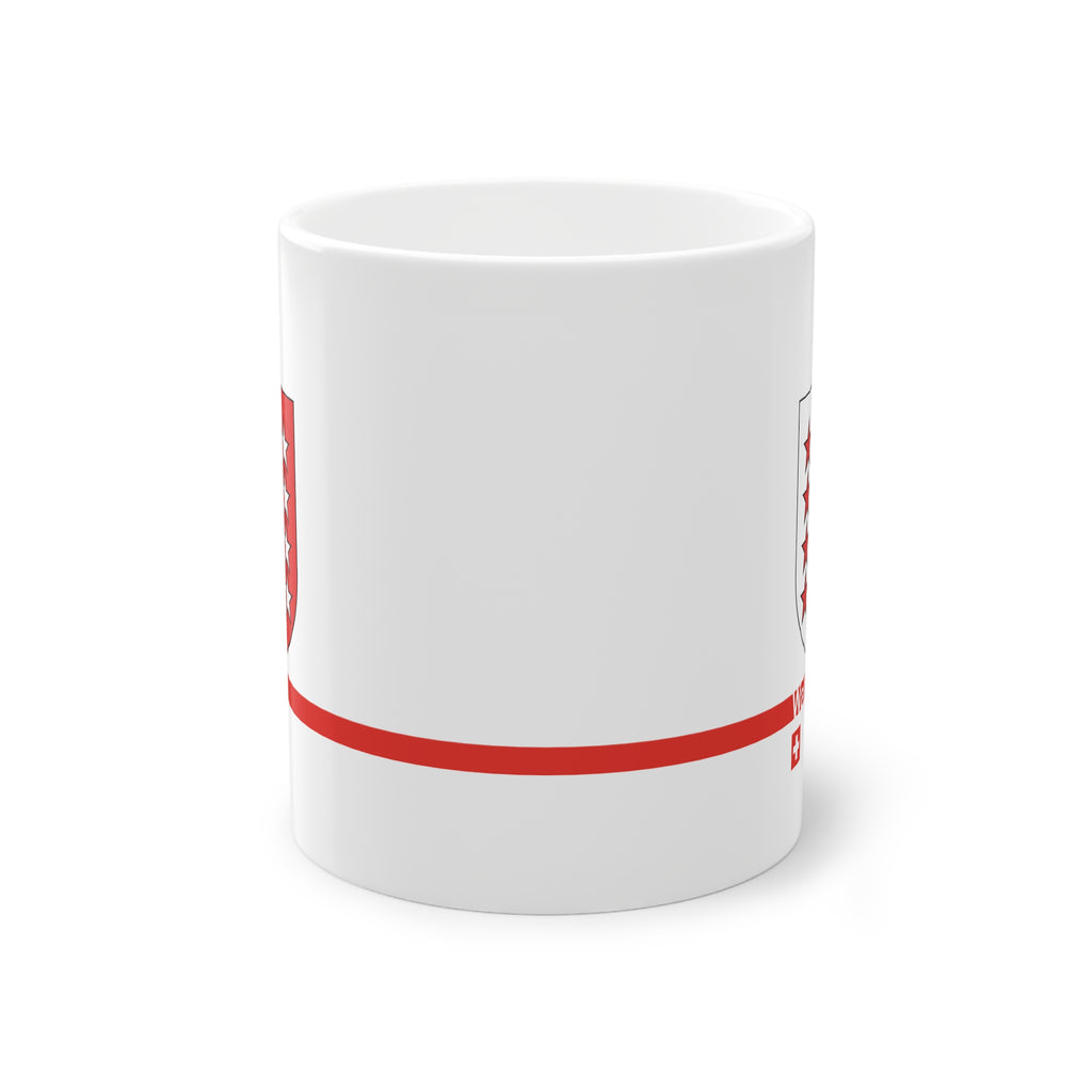 White ceramic mug featuring the red and white Canton of Wallis (Valais) coat of arms with 13 stars, a modern red horizontal line with 'Wallis' text, and a small Swiss cross below.