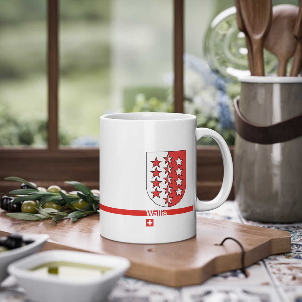 White ceramic mug featuring the red and white Canton of Wallis (Valais) coat of arms with 13 stars, a modern red horizontal line with 'Wallis' text, and a small Swiss cross below.