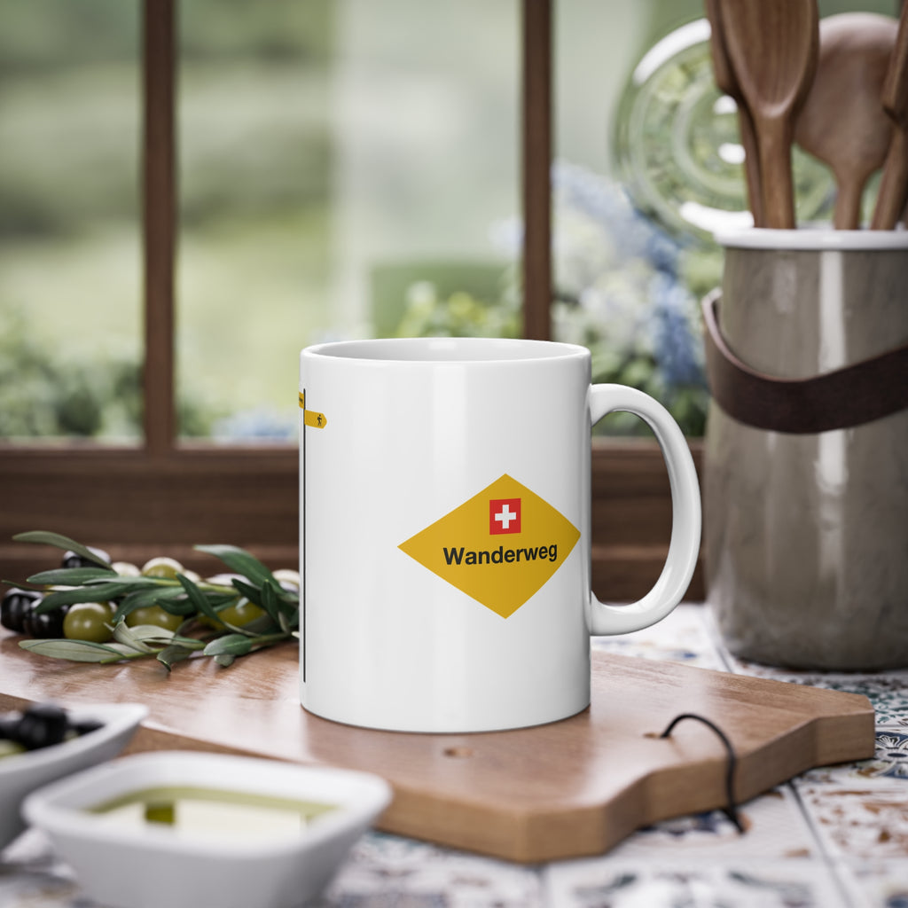 Yellow Swiss hiking trail sign coffee mug on a wooden table