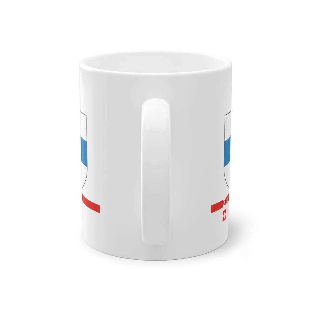 White ceramic mug with the blue and white horizontal coat of arms of the Canton of Zug, Switzerland, featuring a modern red line and a small Swiss cross.